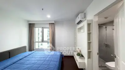 Modern bedroom with ensuite bathroom and large window in urban apartment