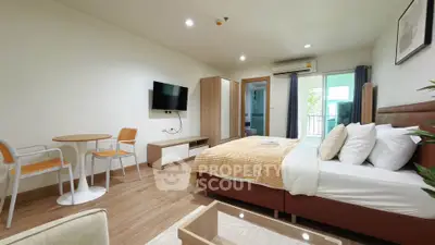 Spacious modern bedroom with cozy decor and balcony access