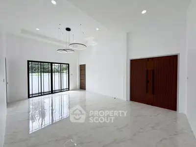 Spacious modern living room with elegant lighting and large windows