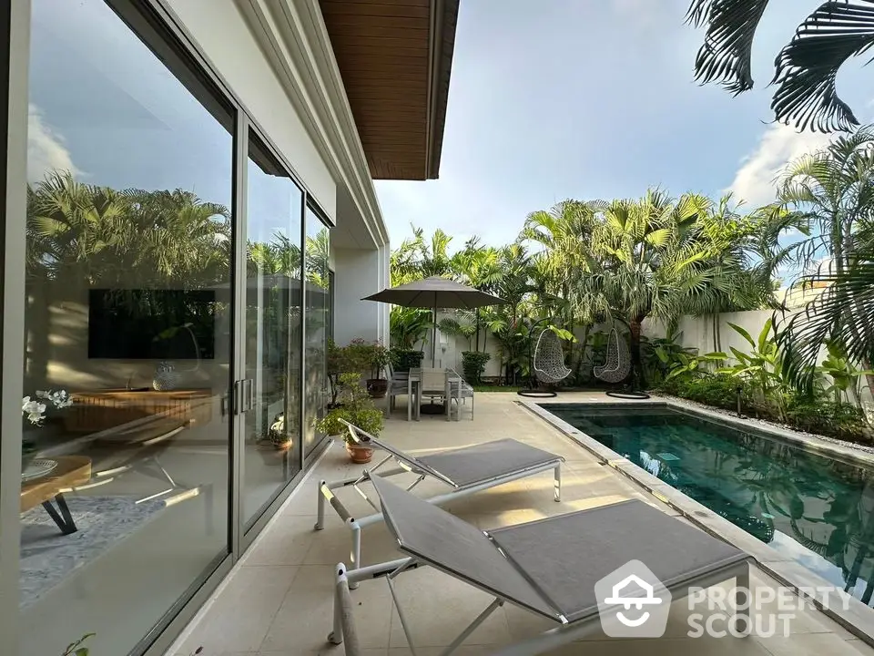 Luxurious tropical villa with private pool and lush garden, perfect for relaxation and entertaining.