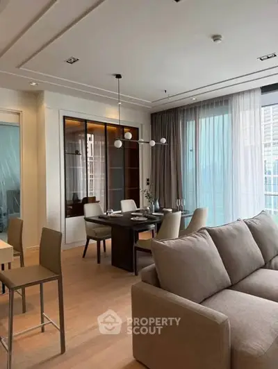 Modern living room with elegant dining area and large windows in a luxury apartment.