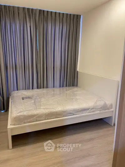 Modern bedroom with sleek design and floor-to-ceiling curtains