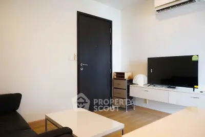 Modern living room with sleek furniture and wall-mounted TV
