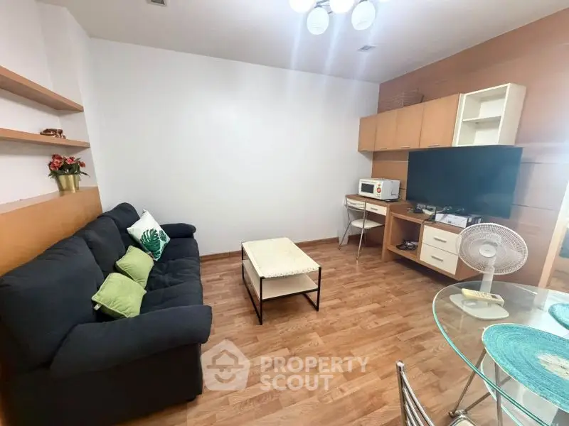 Cozy living room with modern furniture and wooden flooring, perfect for relaxation and entertainment.