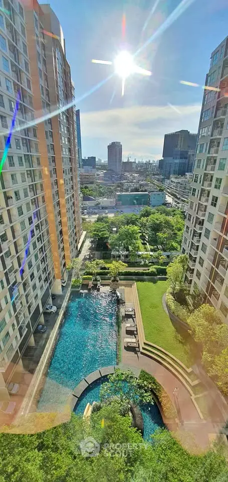 Stunning high-rise view with pool and lush garden in urban setting
