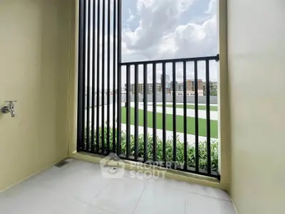 Modern balcony with sleek railing and scenic view of urban landscape.