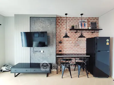 Modern living room with brick wall, mounted TV, and sleek black furniture