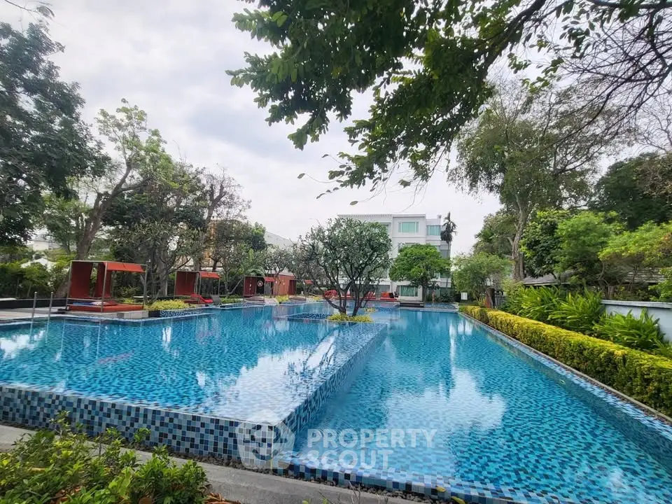 Luxurious outdoor pool area with lush greenery and modern design