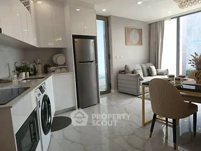 Modern open-plan kitchen and living room with sleek design and natural light.
