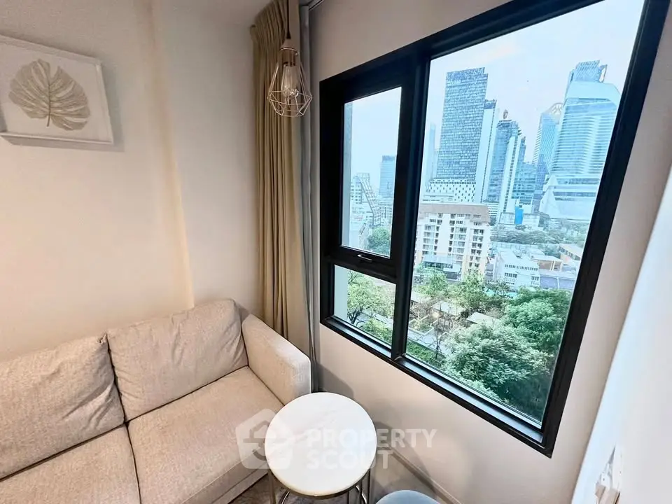 Cozy living room with city view from large window, featuring modern sofa and stylish decor.
