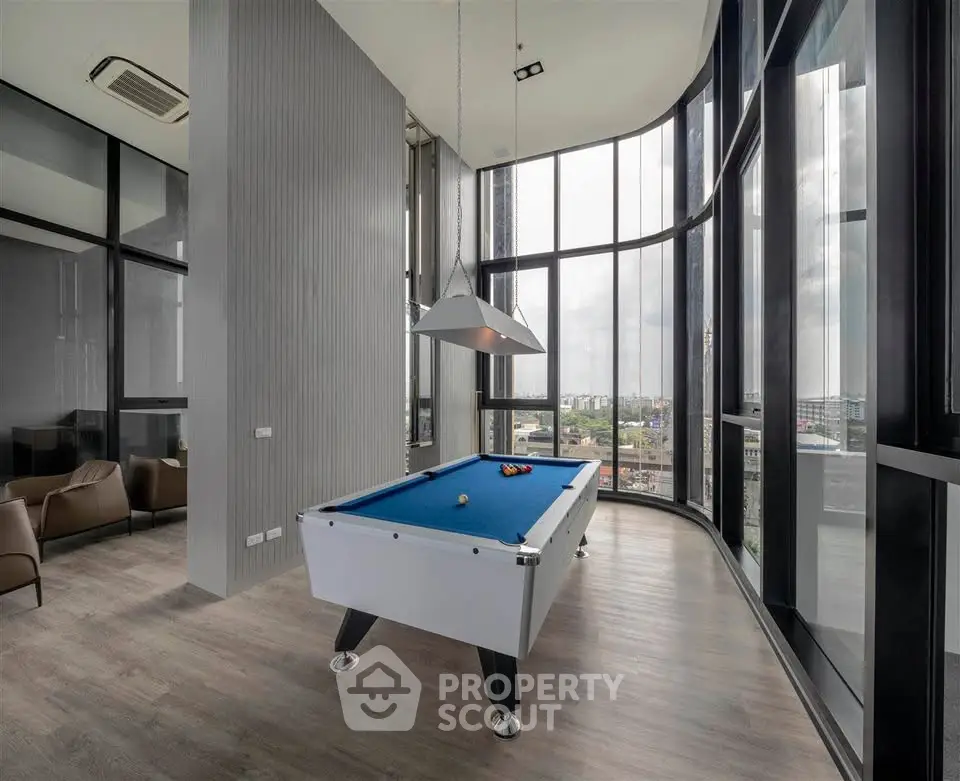 Luxurious high-rise game room with pool table and panoramic city views.