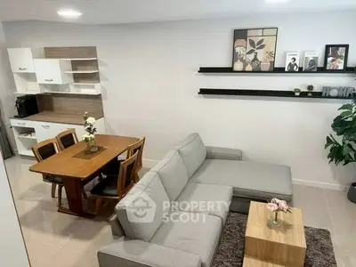 Modern living room with stylish decor and dining area in open layout.