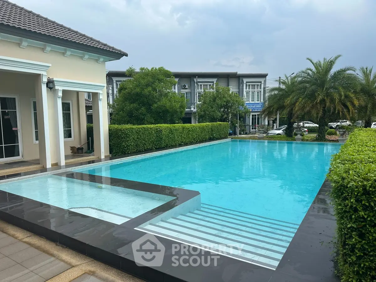 Luxurious residential pool with modern design and lush greenery, perfect for relaxation and leisure.