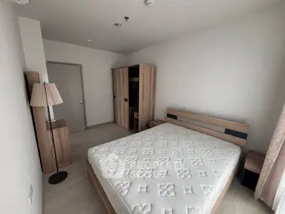 Modern minimalist bedroom with wooden furniture and natural light