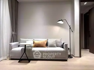 Modern living room with stylish sofa and floor lamp, perfect for relaxation.