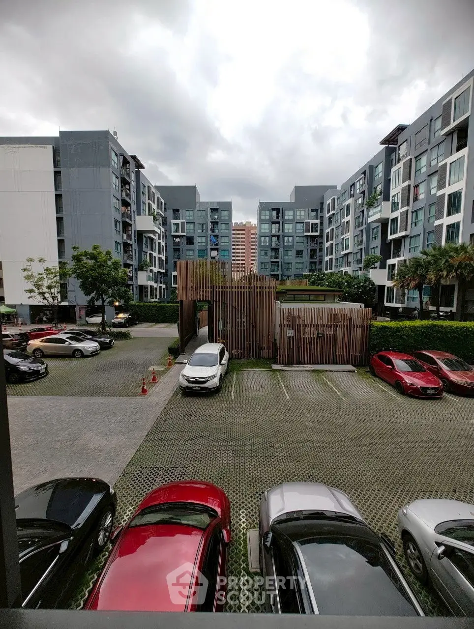 Modern apartment complex with parking area and contemporary architecture