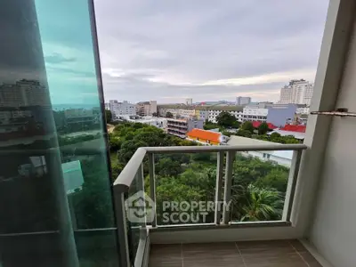 Stunning balcony view overlooking cityscape and lush greenery, perfect for urban living.