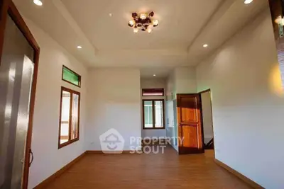 Spacious living room with wooden flooring and modern lighting