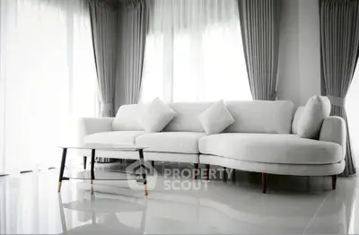 Elegant modern living room with stylish white sofa and chic curtains, perfect for contemporary living.