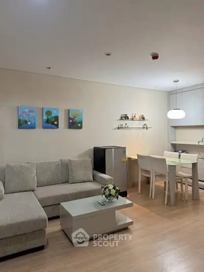 Modern living room with cozy sofa, dining area, and stylish decor in open layout apartment.