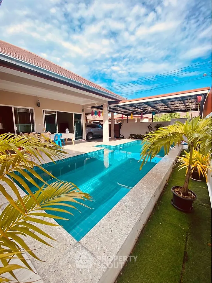 Luxurious villa with private pool and lush greenery, perfect for relaxation and entertainment.