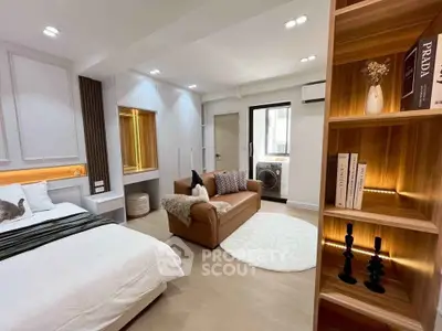 Luxurious modern bedroom with cozy seating area and stylish decor