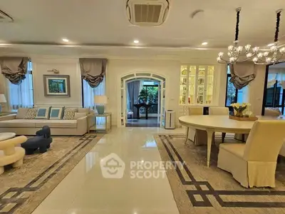 Luxurious living room with elegant decor and spacious dining area, perfect for entertaining guests.