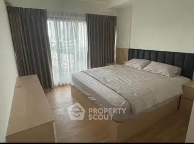 Modern bedroom with large window and elegant curtains