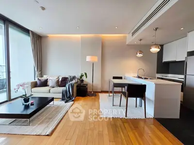 Modern open-plan living room with sleek kitchen and balcony view