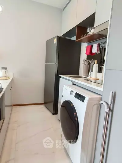 Modern kitchen with sleek appliances and ample storage space