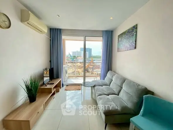 Modern living room with balcony view, stylish furniture, and natural light.