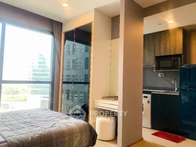 Modern studio apartment with city view, featuring sleek design and integrated appliances.