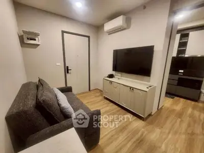 Cozy living room with modern decor and flat-screen TV