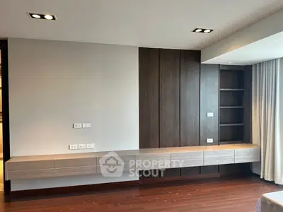 Modern living room with sleek built-in wooden shelves and elegant lighting