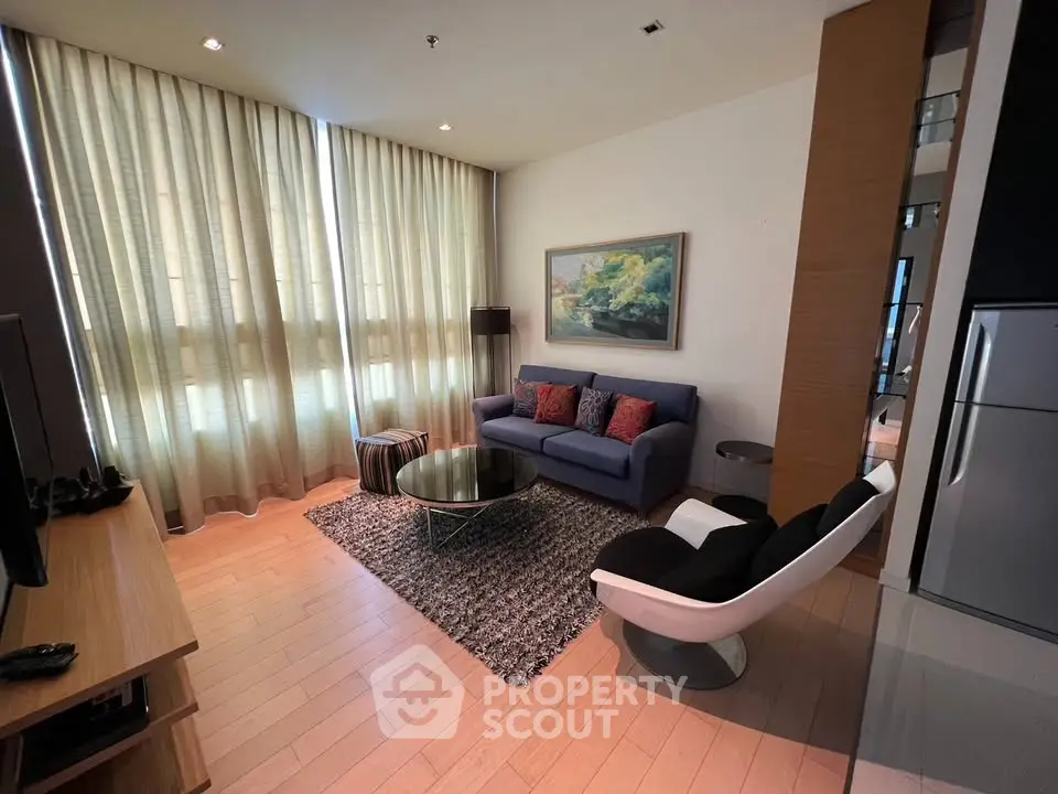 Modern living room with stylish furniture and large windows in a contemporary apartment.