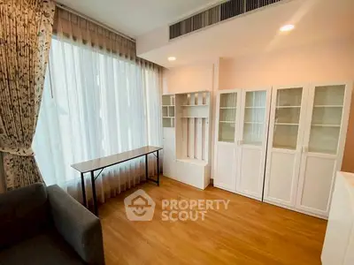 Bright living room with elegant curtains and stylish storage cabinets