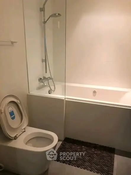 Modern bathroom with bathtub and shower in sleek minimalist design.