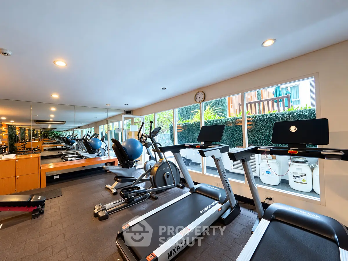 Modern gym with state-of-the-art equipment and large mirrors in a well-lit space.