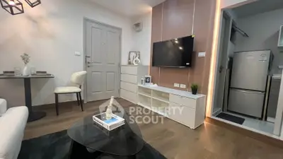 Modern living room with sleek TV setup and cozy dining area