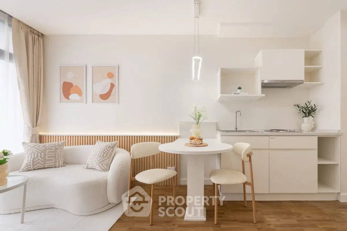Modern open-plan living room and kitchen with stylish decor and natural light.