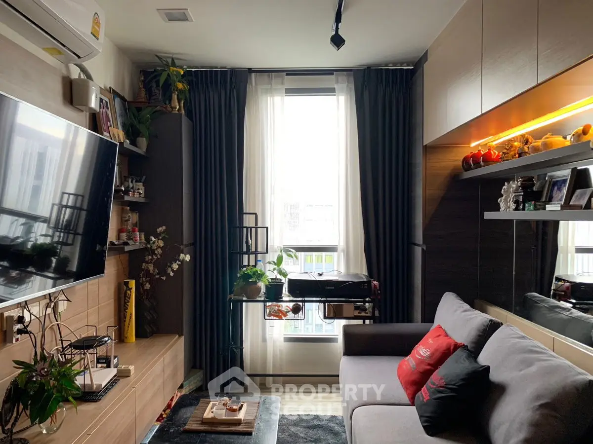 Cozy living room with modern decor and large window for natural light