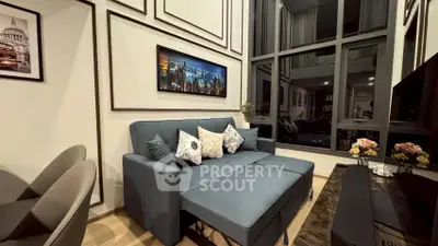 Modern living room with stylish decor and large windows