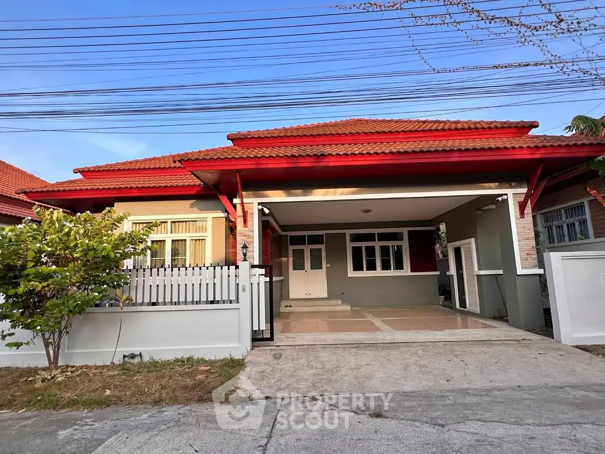 Charming single-story house with red roof and spacious driveway