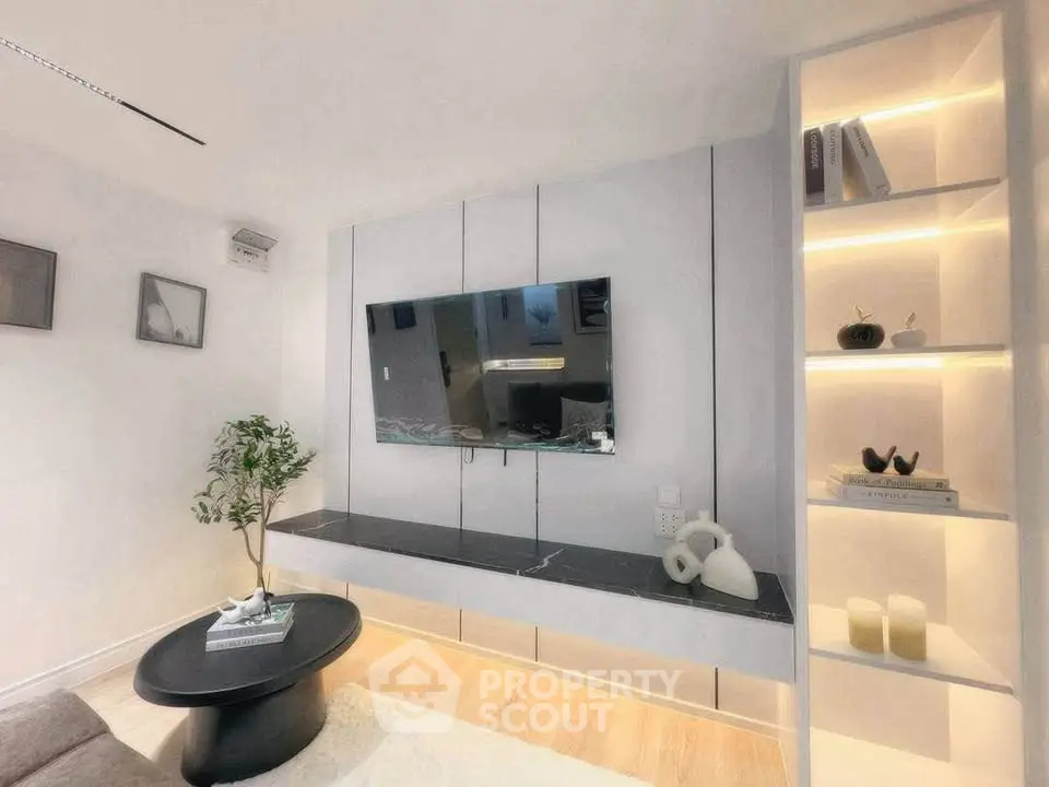 Modern living room with sleek TV setup and stylish shelving
