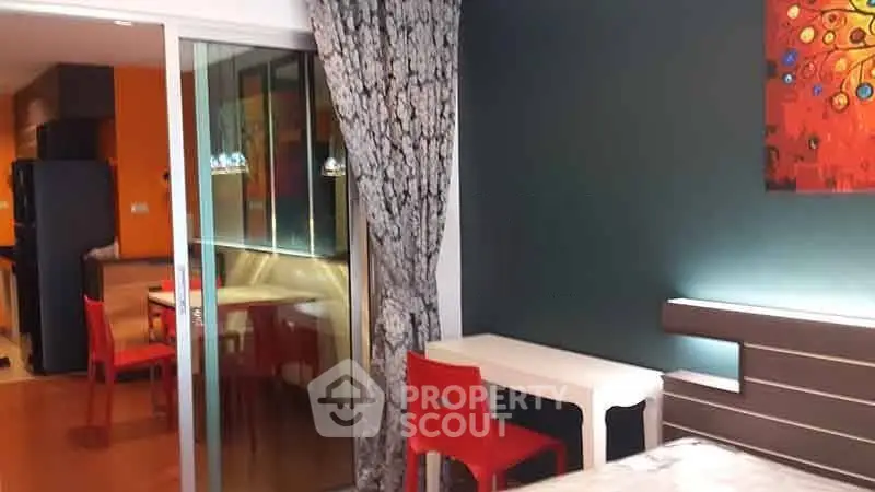 Modern apartment interior with vibrant decor and open layout, featuring a cozy dining area and stylish furnishings.