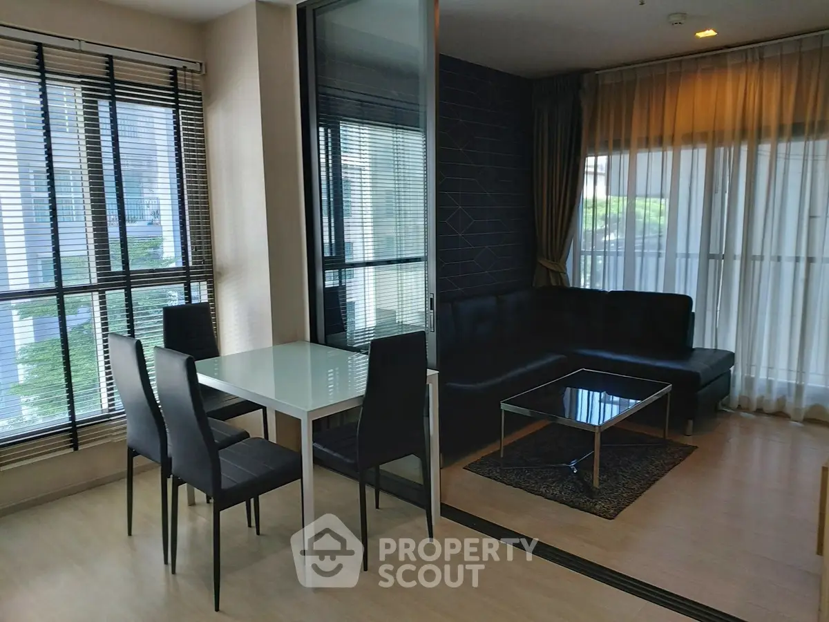 Modern living room with sleek furniture and large windows in a stylish apartment.