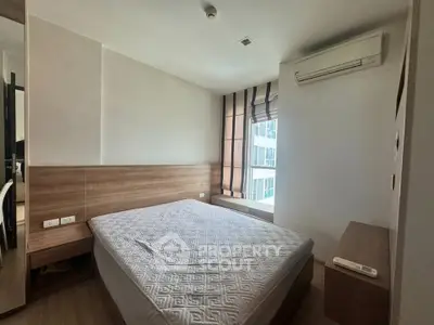 Modern bedroom with large window and air conditioning in a stylish apartment.