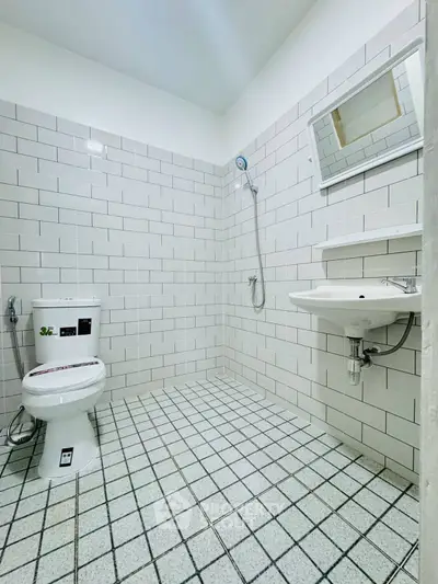 Modern minimalist bathroom with white tiles and sleek fixtures