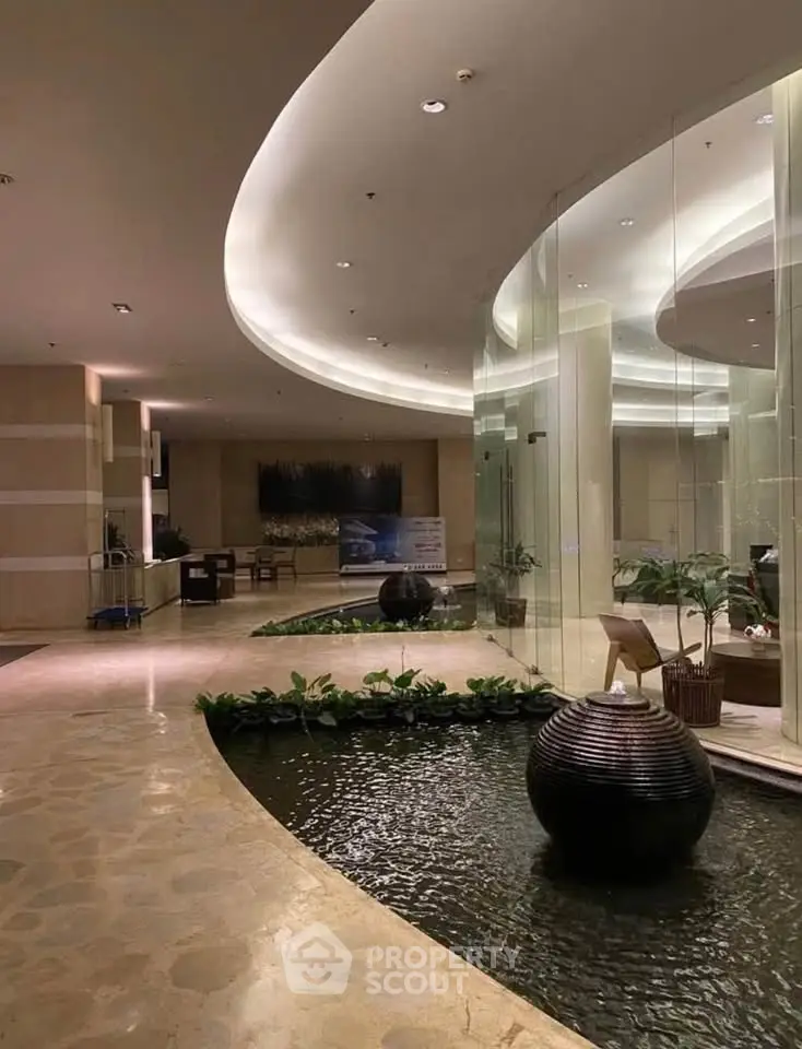 Luxurious building entrance with elegant water feature and modern design