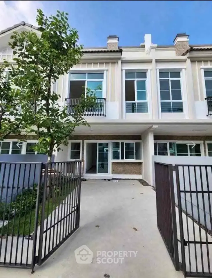 Charming townhouse with modern facade and gated entrance, perfect for families seeking comfort and style.